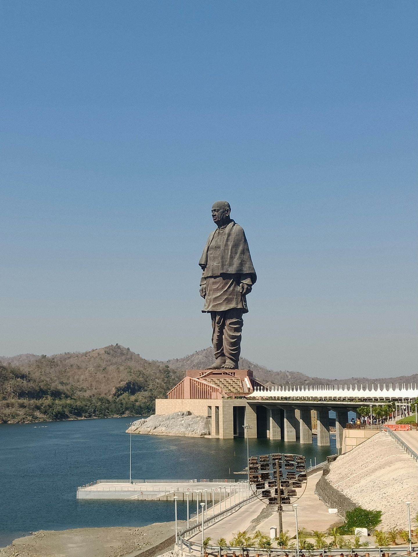 a large statue of a man standing on top of a bridge